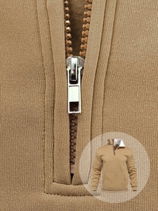 Detailed macro view of camel waffle knit fabric and silver metal half-zipper closure