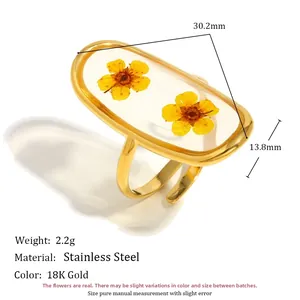 Detailed view of 18K gold plated stainless steel ring with dried yellow flowers in acrylic