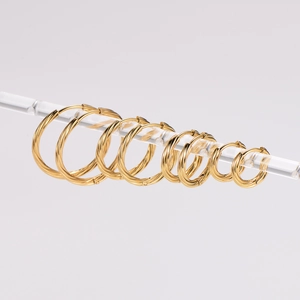 Five pairs of golden stainless steel cable wire hoop earrings in various sizes