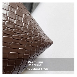 Detailed macro shot of brown woven leather texture with a modern checkered relief pattern