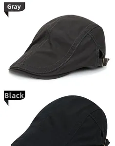 Detail view of cotton flat caps in grey and black with adjustable metal buckles