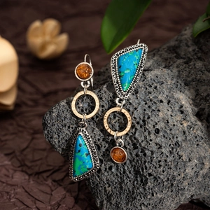 Detailed shot of bohemian lapis stone earrings with hammer-textured golden rings