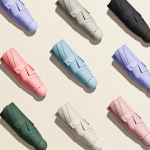 Detailed grid view of compact mini umbrellas in multiple pastel colors and modern style