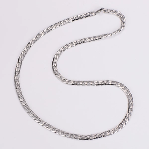 Close-up of silver Cuban chain with textured links and decorative curved bar plate