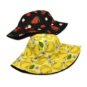 Detail view of cotton bucket hats with red apple and yellow floral patterns for sun protection