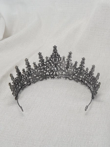 Detailed view of the vintage metal crown featuring intricate filigree work and rhinestones