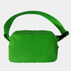 Detail view of the green waterproof nylon waist bag with adjustable strap and buckle