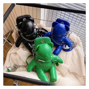 Detailed view of three cute bear PU leather bags in black, blue, and green with chain straps