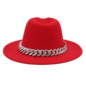Detail of red fedora hat featuring a sparkling rhinestone encrusted silver metal chain band