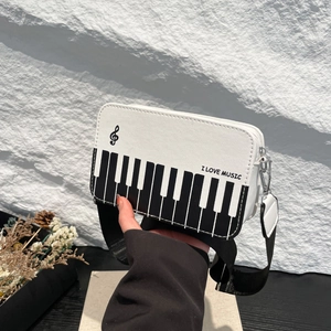 Crossbody bag with piano keyboard pattern and I Love Music slogan with wide strap