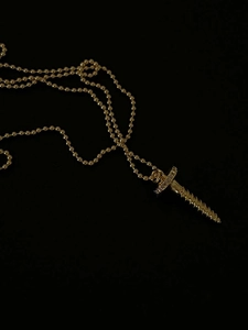 Detailed view of an 18k gold plated screw-shaped pendant necklace with tiny zircon stones