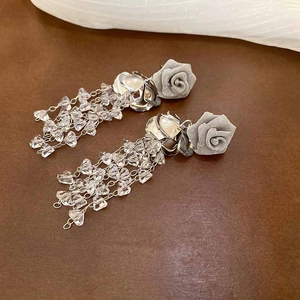 Detail of rose tassel earrings with silver chains, mesh petals, and crystal beads