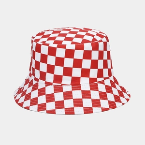Macro detail of red and white checkerboard canvas fabric on a reversible bucket hat