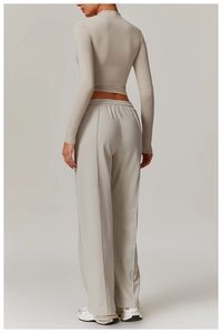 Detail view of high-waist light grey wide-leg sweatpants with vertical seam design