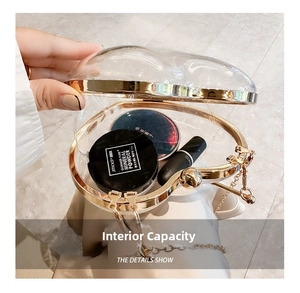Detail view of heart-shaped acrylic bag showing large internal storage capacity