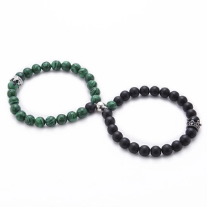 Detail of magnetic stone bracelets for couples showing heart attraction and crown charms
