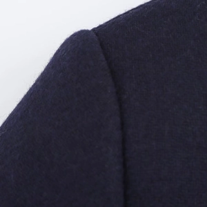 Detail of navy blue wool blend coat showing fabric texture and shoulder seam stitching