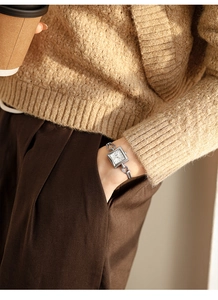 Chic women's square dial silver watch shown on wrist with casual autumn outfit