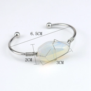 Detail view of handmade copper wire wrapped opal bracelet with dimensions 6.5cm diameter