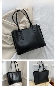 Close-up of black tote bag featuring fine lychee grain texture and minimalist slim straps