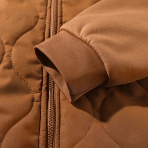 Men's brown quilted winter jacket with ribbed cuffs and wave pattern stitching