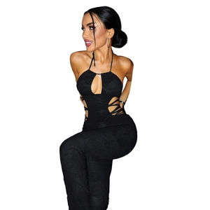 Detail of black cut-out jumpsuit with criss-cross lacing and floral texture fabric