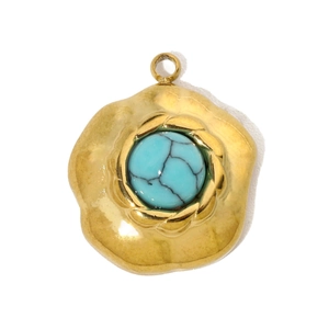Detailed view of vintage gold steel pendant with a turquoise stone inlay piece