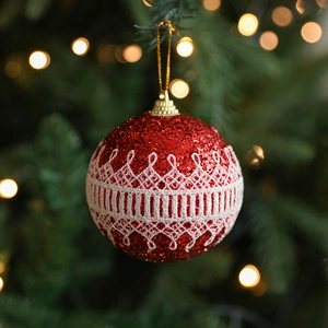 8cm red Christmas foam ball with white lace trim and glitter hanging on tree branch