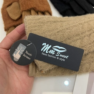 Close-up of fluffy touch screen knitted gloves with brand tags in various colors