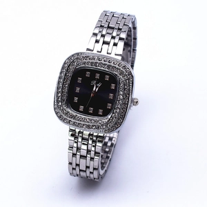 Detail of a square silver watch featuring a black dial with sparkling crystal accents