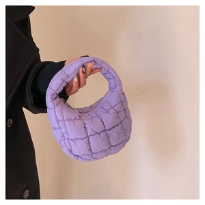 Detailed view of the purple quilted cloud bag texture and nylon fabric finish