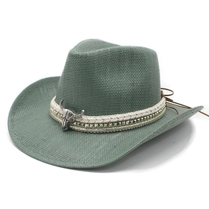 Sage green woven straw western cowboy hat with vintage steer skull pendant and studs