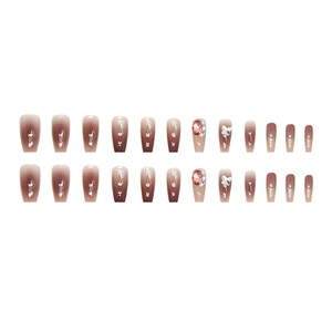 Ombre dusty pink press-on nails with sparkling rhinestones and white bow accents