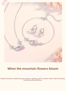 Close-up of 925 silver jewelry set with pink heart-shaped zircons and micro-pave details