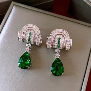 Vintage style silver drop earrings with white zircon arch and pear shaped green gemstone