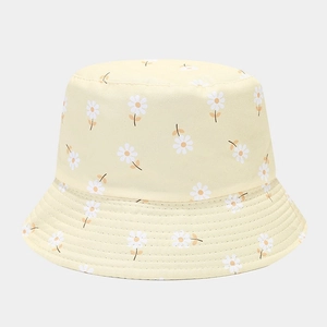 Detailed view of yellow floral bucket hat with white daisy prints and reinforced stitching