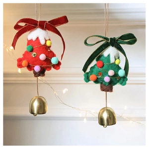 Close-up of red and green felt Christmas tree ornaments with velvet ribbons and gold bells