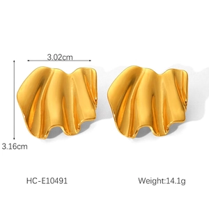 Detailed view of gold irregular crinkle wave earrings measuring 3.02cm by 3.16cm