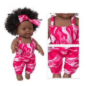 Close-up of pink camo outfit stitching and soft fabric detail on 12-inch African doll