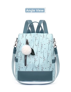 Vue frontale du sac à dos floral bleu clair avec pompon blanc et bretelles bleu marine