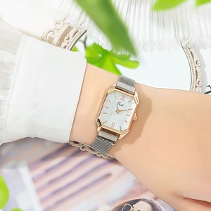Fashionable square rose gold watch with mesh strap worn on a stylish wrist