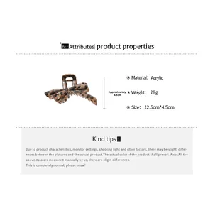 Detail view of acrylic leopard print bow hair claw clip with dimensions 12.5cm by 4.5cm