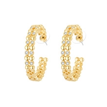 Detail of gold-plated C-shaped earrings with two rows of sparkling white rhinestones