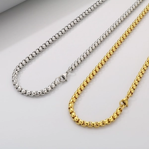 Detail view of silver and gold stainless steel box chains with secure lobster clasps