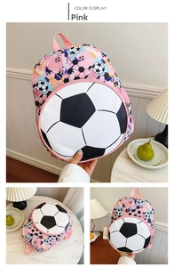 Detail of pink kids football backpack showing soccer patterns and 3D ball-shaped front pocket
