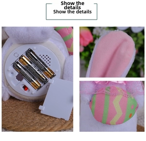 Detail view of the battery compartment, red switch and soft plush ears on this rabbit toy