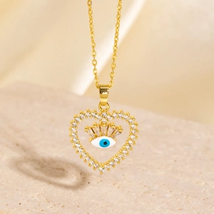 Macro view of heart-shaped evil eye pendant with blue enamel and zircon details