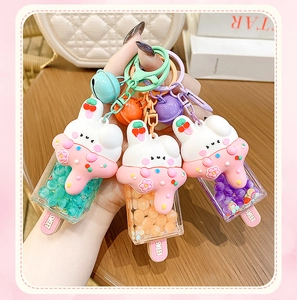 Detailed shot of bunny ice cream keychains in mint green, orange and purple resin colors