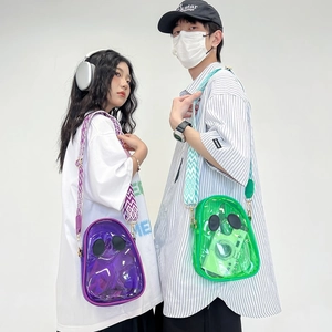 Transparent PVC jelly crossbody bags in purple and green with wavy wide shoulder straps