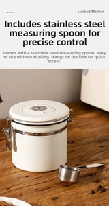 Creamy stainless steel coffee canister featuring date tracker lid and metal measuring scoop